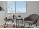 Sitting area with chairs, side table, and natural light from the window at 529 59Th S Way, St Petersburg, FL 33707