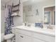 Bathroom featuring double sinks with modern fixtures, quartz countertops, a shower and decorative nautical art at 5519 Tripoli Dr, Palmetto, FL 34221