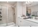 Well-lit bathroom with double sinks, quartz countertops, a glass-enclosed shower, and modern fixtures at 5519 Tripoli Dr, Palmetto, FL 34221