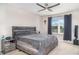 Cozy bedroom with a gray bed frame and bedding, a window with natural light, and minimalist decor at 5519 Tripoli Dr, Palmetto, FL 34221