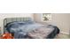 Bedroom with a window and a gray-blue bed cover and decorative pillows at 5519 Tripoli Dr, Palmetto, FL 34221