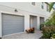 Close-up of townhome garage, charming exterior lighting, and manicured landscaping at 5519 Tripoli Dr, Palmetto, FL 34221