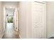 Bright hallway featuring wood-look tile flooring and white doors at 5519 Tripoli Dr, Palmetto, FL 34221