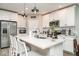 Modern kitchen featuring white cabinetry, stainless steel appliances, a subway tile backsplash, and an island with seating at 5519 Tripoli Dr, Palmetto, FL 34221