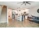 Open-concept living room showcasing the kitchen, hardwood floors, and modern decor elements, with a staircase on the left at 5519 Tripoli Dr, Palmetto, FL 34221