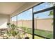 Screened-in patio with greenery and a view of the backyard and blue sky at 5519 Tripoli Dr, Palmetto, FL 34221