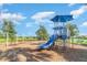 The playground boasts a bright blue slide, a swing set, and plenty of space for children to explore and play at 5519 Tripoli Dr, Palmetto, FL 34221