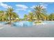 Resort style pool with large palms, cabanas, and beautiful blue skies creating a true oasis for relaxation at 5519 Tripoli Dr, Palmetto, FL 34221