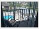 Relaxing balcony view of the pool and landscaped community at 5541 Bay Blvd # 405, Port Richey, FL 34668