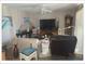 Comfortable living room with a ceiling fan, large television, and a variety of decorations at 5541 Bay Blvd # 405, Port Richey, FL 34668