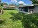 Spacious backyard with screen porch, providing ample room for outdoor activities and relaxation at 5630 47Th N Ave, Kenneth City, FL 33709