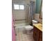 A well-lit bathroom features a shower-tub combo and a classic vanity, perfect for relaxation at 5630 47Th N Ave, Kenneth City, FL 33709