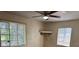 Bedroom with neutral walls, a ceiling fan, and natural lighting from two windows at 5630 47Th N Ave, Kenneth City, FL 33709