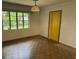 The bedroom has parquet flooring and ample natural light, ready for personalization at 5630 47Th N Ave, Kenneth City, FL 33709