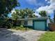 Single-story home featuring a vibrant blue garage door and clean architectural lines at 5630 47Th N Ave, Kenneth City, FL 33709