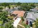 Aerial view shows the home's lush landscaping, and proximity to surrounding homes and community features at 603 Ivey Ln, Tarpon Springs, FL 34689