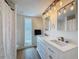 Bathroom with a double sink vanity, decorative lighting, and a window at 603 Ivey Ln, Tarpon Springs, FL 34689