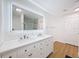 Modern bathroom featuring double sinks, an illuminated mirror, and a glass-enclosed shower at 603 Ivey Ln, Tarpon Springs, FL 34689