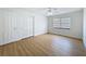 Empty bedroom with wood floors, a large window, and a spacious closet at 603 Ivey Ln, Tarpon Springs, FL 34689