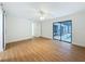 Bright, spacious bedroom with wood floors, a ceiling fan, and sliding glass doors leading to a pool area at 603 Ivey Ln, Tarpon Springs, FL 34689