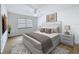 Staged bedroom featuring a neutral color palette, a large window, and modern furniture at 603 Ivey Ln, Tarpon Springs, FL 34689