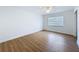 Empty bedroom featuring wood floors, a large window, and a spacious closet at 603 Ivey Ln, Tarpon Springs, FL 34689