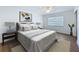 Staged bedroom featuring a neutral color palette, a large window, and soft lighting at 603 Ivey Ln, Tarpon Springs, FL 34689