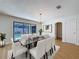 Elegant dining room featuring a glass table, stylish chairs, and a view of the pool area at 603 Ivey Ln, Tarpon Springs, FL 34689