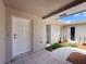 Inviting front entrance with a decorative door, tile flooring, and desert-inspired landscaping at 603 Ivey Ln, Tarpon Springs, FL 34689