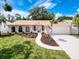 Charming single-story home with a well-manicured lawn and neutral color scheme at 603 Ivey Ln, Tarpon Springs, FL 34689