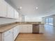 Modern kitchen showcasing granite countertops, stainless steel appliances, and white cabinetry at 603 Ivey Ln, Tarpon Springs, FL 34689