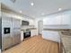 Modern kitchen showcasing stainless steel appliances, granite countertops, and white cabinets at 603 Ivey Ln, Tarpon Springs, FL 34689