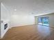 Bright living room featuring a modern fireplace, hardwood floors, and access to the pool area at 603 Ivey Ln, Tarpon Springs, FL 34689