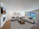 Tastefully furnished living room with fireplace, sleek decor, and views of the pool at 603 Ivey Ln, Tarpon Springs, FL 34689