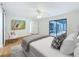 Bright main bedroom featuring modern decor, a ceiling fan, and access to the pool area at 603 Ivey Ln, Tarpon Springs, FL 34689