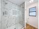 Beautiful glass shower with white marble, a rain shower head, and built-in shelving at 603 Ivey Ln, Tarpon Springs, FL 34689