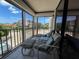 Enjoy tranquil views from this balcony, complete with comfy seating, creating an inviting outdoor living space at 6218 Palma Del Mar # 303, St Petersburg, FL 33715