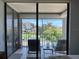 Serene balcony overlooking lush surroundings, perfect for relaxation with comfortable seating and sliding glass doors at 6218 Palma Del Mar # 303, St Petersburg, FL 33715