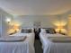 Bedroom with two double beds, lamps and a painting on the wall at 6218 Palma Del Mar # 303, St Petersburg, FL 33715