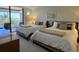 Bright bedroom with two beds and sliding doors to a patio at 6218 Palma Del Mar # 303, St Petersburg, FL 33715