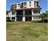 Exterior of condo units featuring balconies, a red tile roof, and tropical landscaping at 6218 Palma Del Mar # 303, St Petersburg, FL 33715
