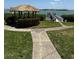 Community gazebo, mature landscaping, and walkway lead to a beautiful waterfront pier at 6218 Palma Del Mar # 303, St Petersburg, FL 33715