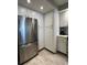 Clean kitchen with stainless steel refrigerator and white cabinets, offering lots of storage at 6218 Palma Del Mar # 303, St Petersburg, FL 33715
