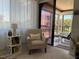 Living room seating area featuring light filtering curtains and access to outdoor balcony at 6218 Palma Del Mar # 303, St Petersburg, FL 33715