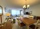 Bright living room with a dining area with a wood table and six chairs at 6218 Palma Del Mar # 303, St Petersburg, FL 33715