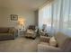 Comfortable seating arrangement in living room area with light filtering curtains at 6218 Palma Del Mar # 303, St Petersburg, FL 33715