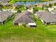 A high aerial view shows home's lush backyard, screened lanai, mature trees, and peaceful pond views at 644 Chipper Dr, Sun City Center, FL 33573