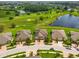 Beautiful aerial view of homes on well-manicured lawns in a community near ponds and golf course at 644 Chipper Dr, Sun City Center, FL 33573