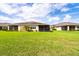 Large backyard featuring a well-manicured lawn and screened in patio at 644 Chipper Dr, Sun City Center, FL 33573