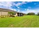 Nice backyard with green grass and a screened-in porch with a pretty view at 644 Chipper Dr, Sun City Center, FL 33573